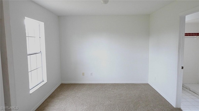 spare room with light colored carpet