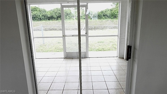 doorway to outside with light tile patterned floors