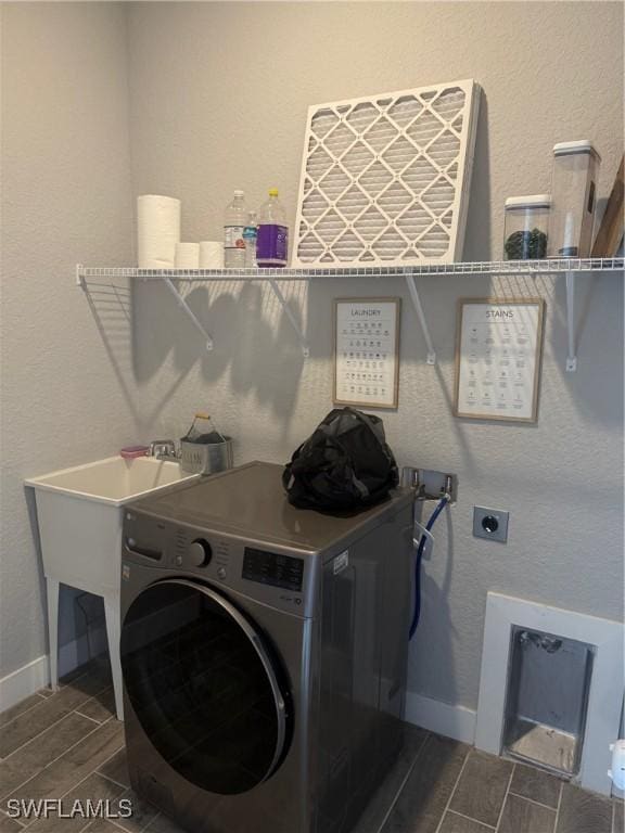 washroom with dark hardwood / wood-style flooring and washer / dryer