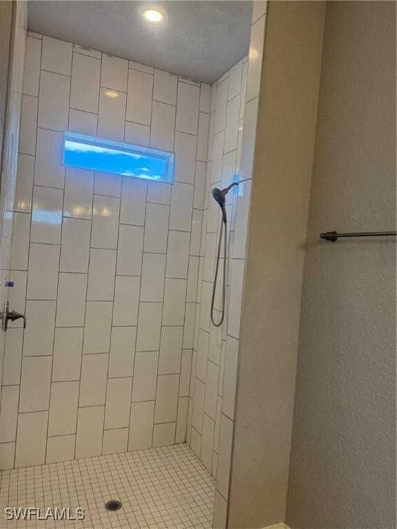 bathroom with a tile shower