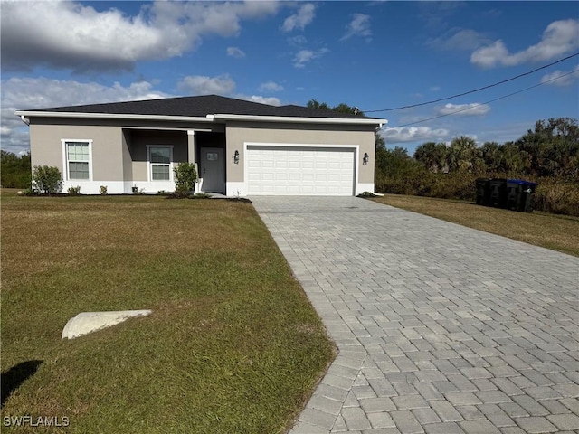 view of front of home with a front yard and a garage