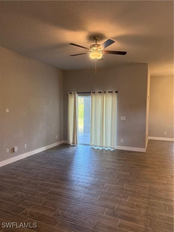 empty room featuring a textured ceiling, dark hardwood / wood-style floors, and ceiling fan