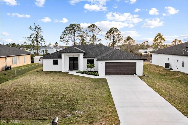 view of front of property featuring cooling unit, concrete driveway, an attached garage, and a front lawn