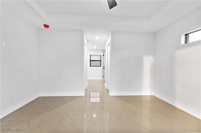 unfurnished room with a tray ceiling