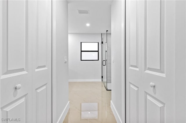 hallway with light tile patterned floors