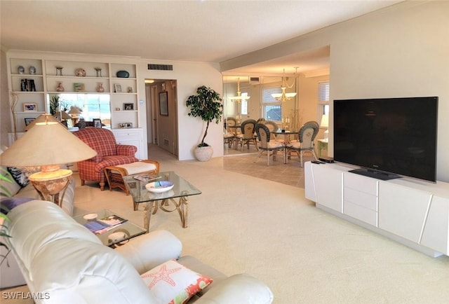 living room featuring light colored carpet and a notable chandelier