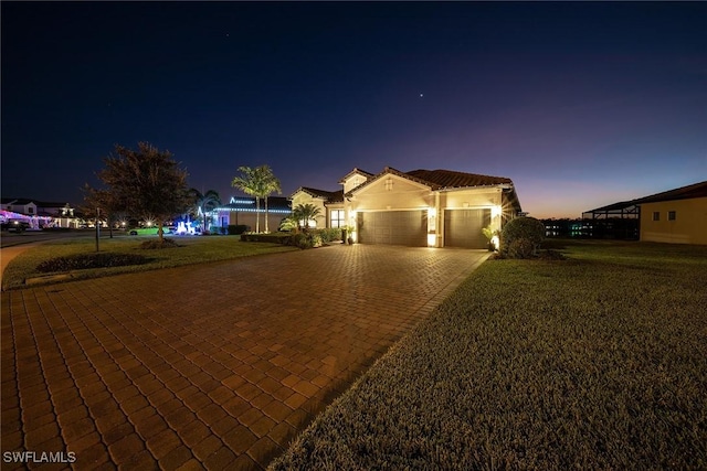 view of front facade with a garage and a front lawn