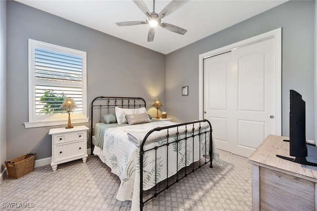 carpeted bedroom with ceiling fan and a closet