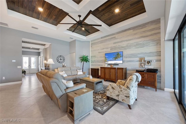 tiled living room featuring french doors, coffered ceiling, wood ceiling, ceiling fan, and beam ceiling