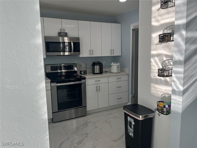 kitchen featuring white cabinets and appliances with stainless steel finishes