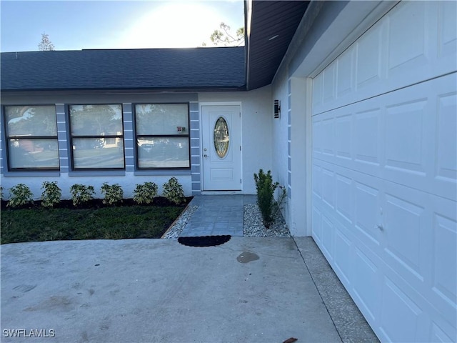 view of exterior entry featuring a garage