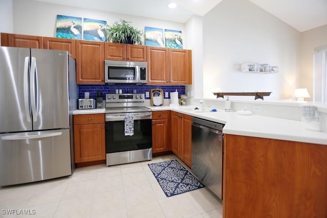 kitchen featuring tasteful backsplash, lofted ceiling, sink, light tile patterned floors, and stainless steel appliances