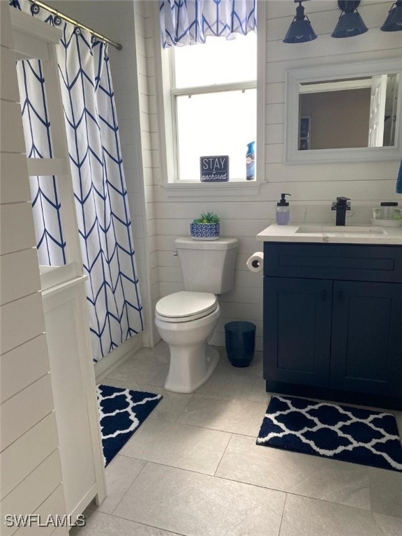 bathroom with tile patterned flooring, vanity, curtained shower, and toilet