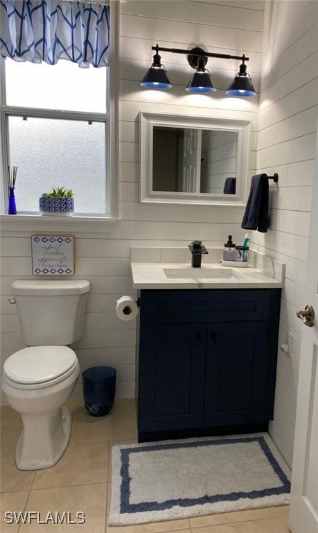 bathroom with vanity, toilet, and tile patterned flooring