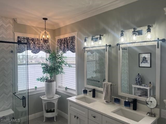 bathroom with vanity, a notable chandelier, and walk in shower