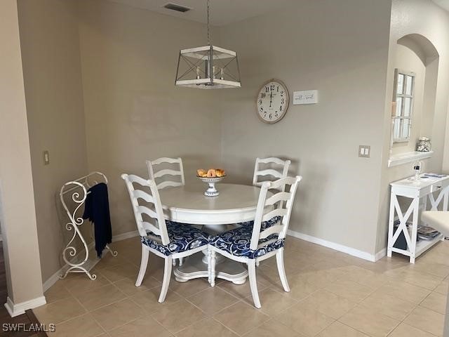 dining area with light tile patterned floors