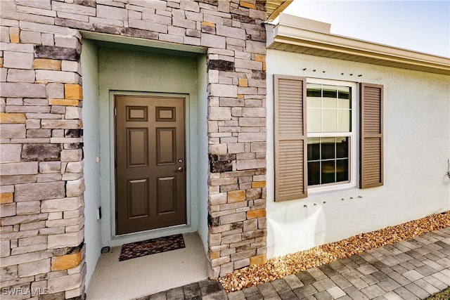 16351 Coconut Palm Dr, Port Charlotte, FL 33953 - doorway to property with stone siding