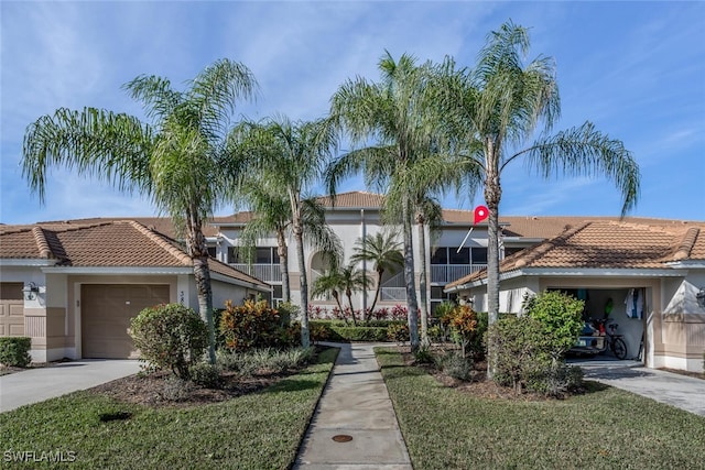 view of property featuring driveway and an attached garage