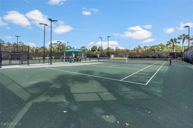 view of tennis court with fence