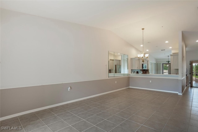 tiled spare room with recessed lighting, vaulted ceiling, baseboards, and an inviting chandelier