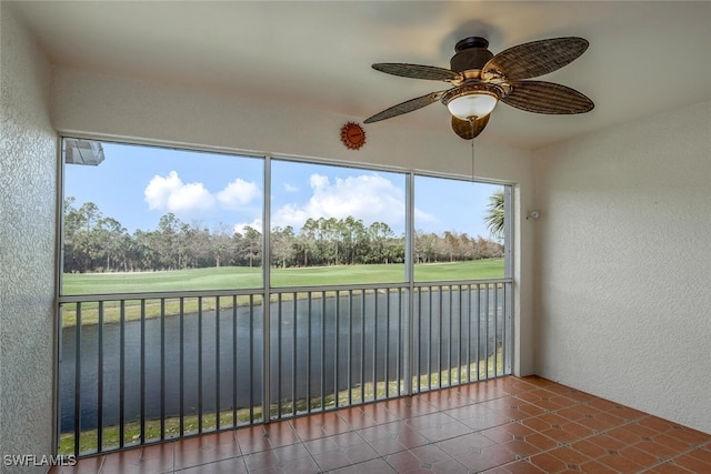 unfurnished sunroom featuring a ceiling fan