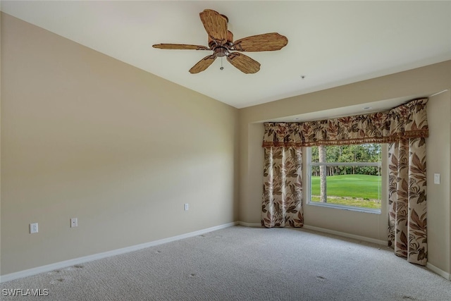 carpeted empty room with ceiling fan and baseboards