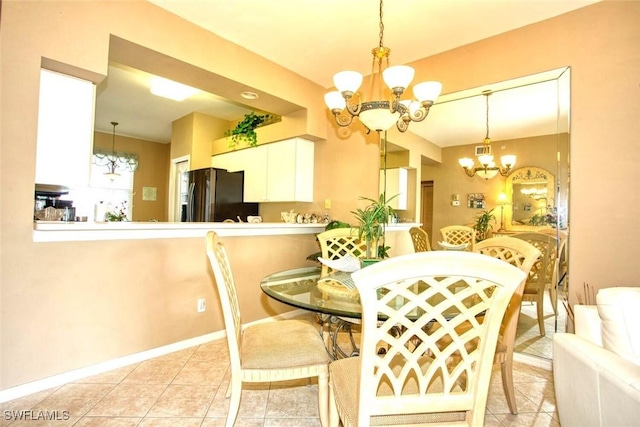 dining area featuring a notable chandelier and light tile patterned floors