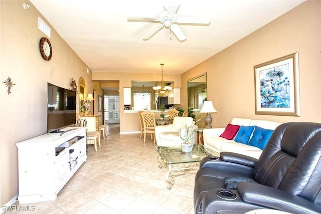 living room featuring ceiling fan with notable chandelier and light tile patterned flooring