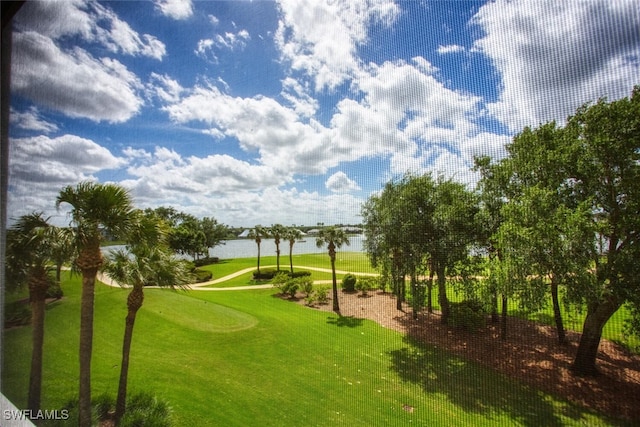 surrounding community with a lawn and a water view