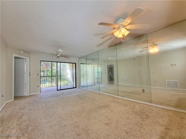 carpeted empty room featuring ceiling fan and lofted ceiling