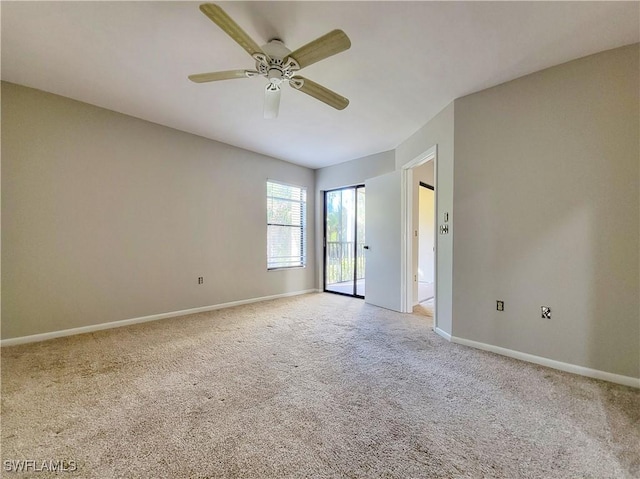 spare room featuring ceiling fan and light carpet