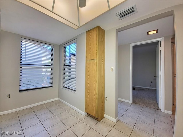 tiled empty room featuring a wealth of natural light