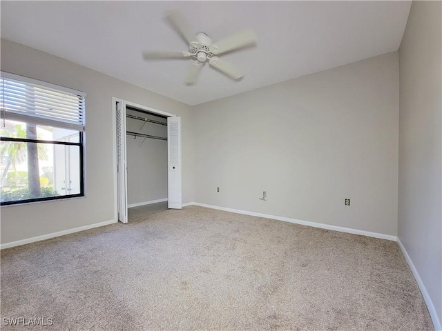 unfurnished bedroom featuring carpet floors, ceiling fan, and a closet