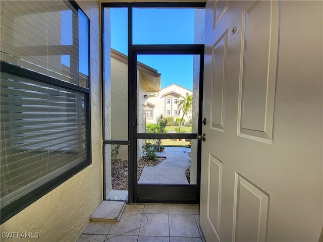 entryway featuring light tile patterned floors