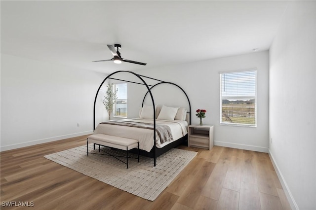 bedroom with ceiling fan and light hardwood / wood-style floors