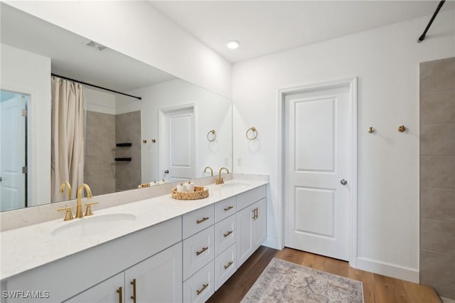 bathroom featuring a shower with curtain, vanity, and hardwood / wood-style flooring