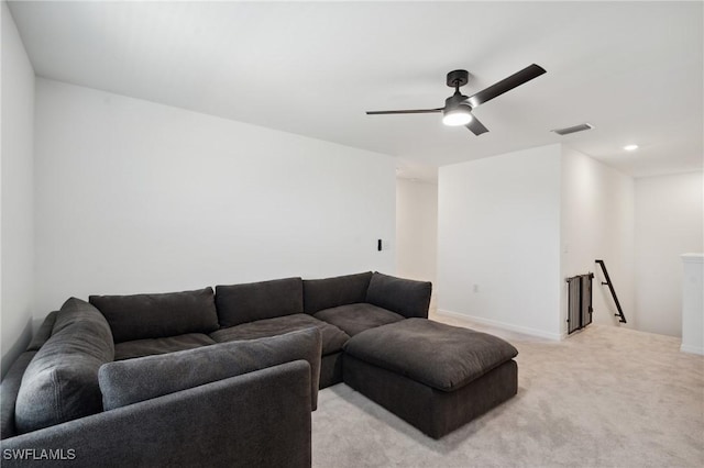 carpeted living room with ceiling fan