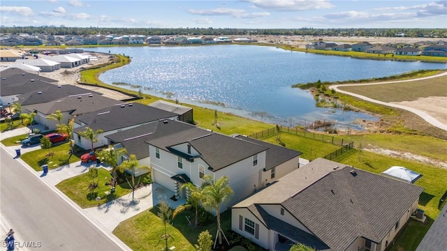 birds eye view of property with a water view