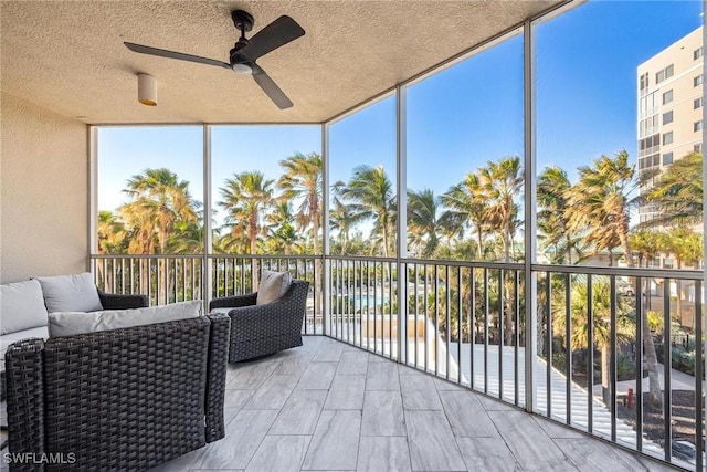 sunroom / solarium featuring ceiling fan