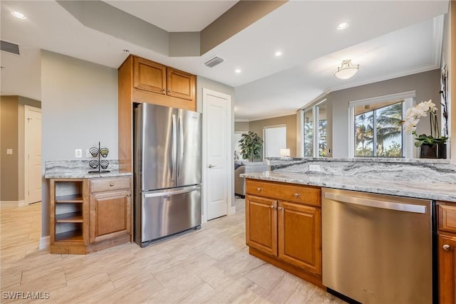 kitchen featuring light stone countertops, ornamental molding, and appliances with stainless steel finishes