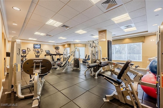 gym featuring a drop ceiling and crown molding