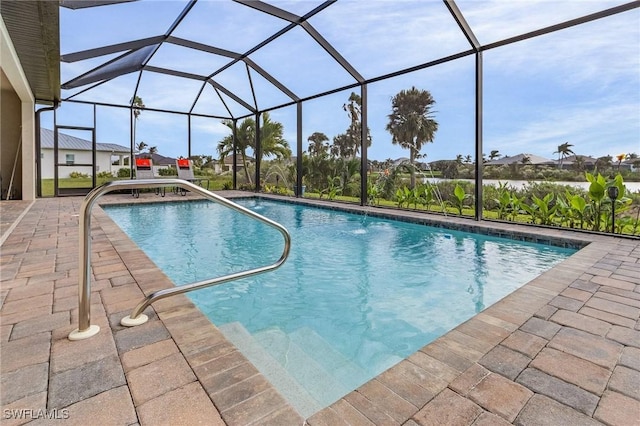 view of swimming pool featuring pool water feature, glass enclosure, and a patio