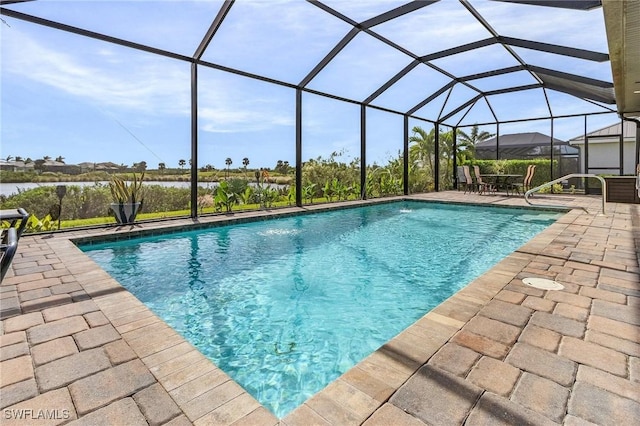 view of pool with glass enclosure and a patio area