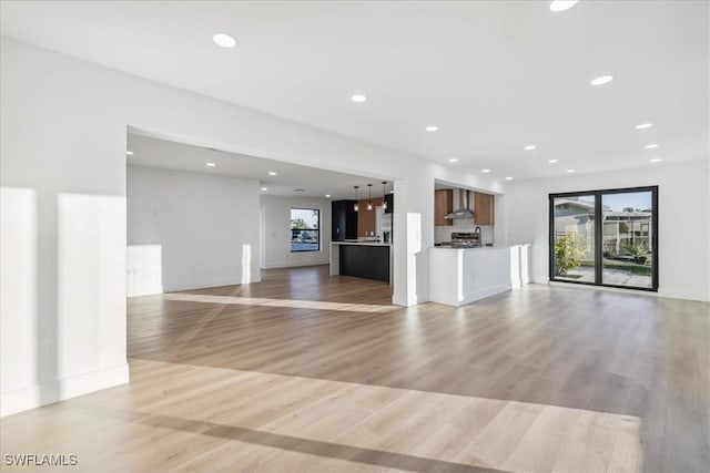 unfurnished living room featuring light wood-type flooring