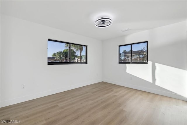 unfurnished room featuring light hardwood / wood-style floors