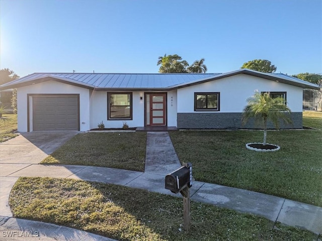 ranch-style house featuring a front lawn and a garage