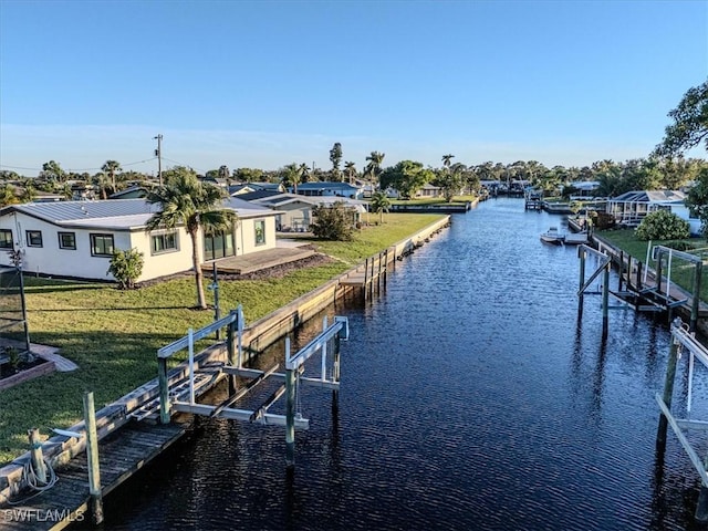 view of dock featuring a yard and a water view