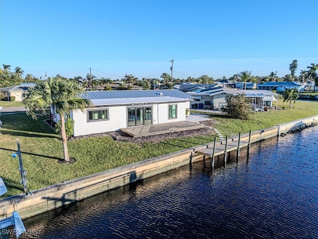 view of dock featuring a lawn, a patio, and a water view