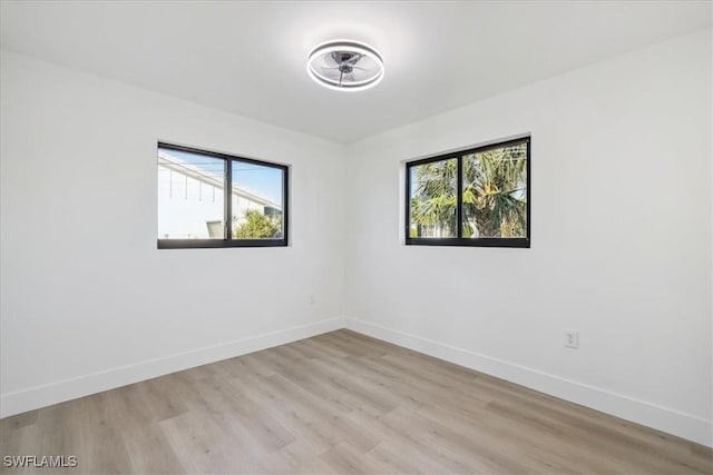 unfurnished room with light hardwood / wood-style floors