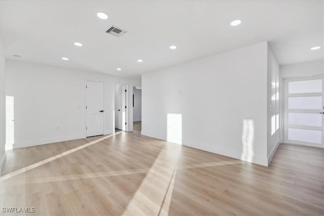 spare room featuring light wood-type flooring